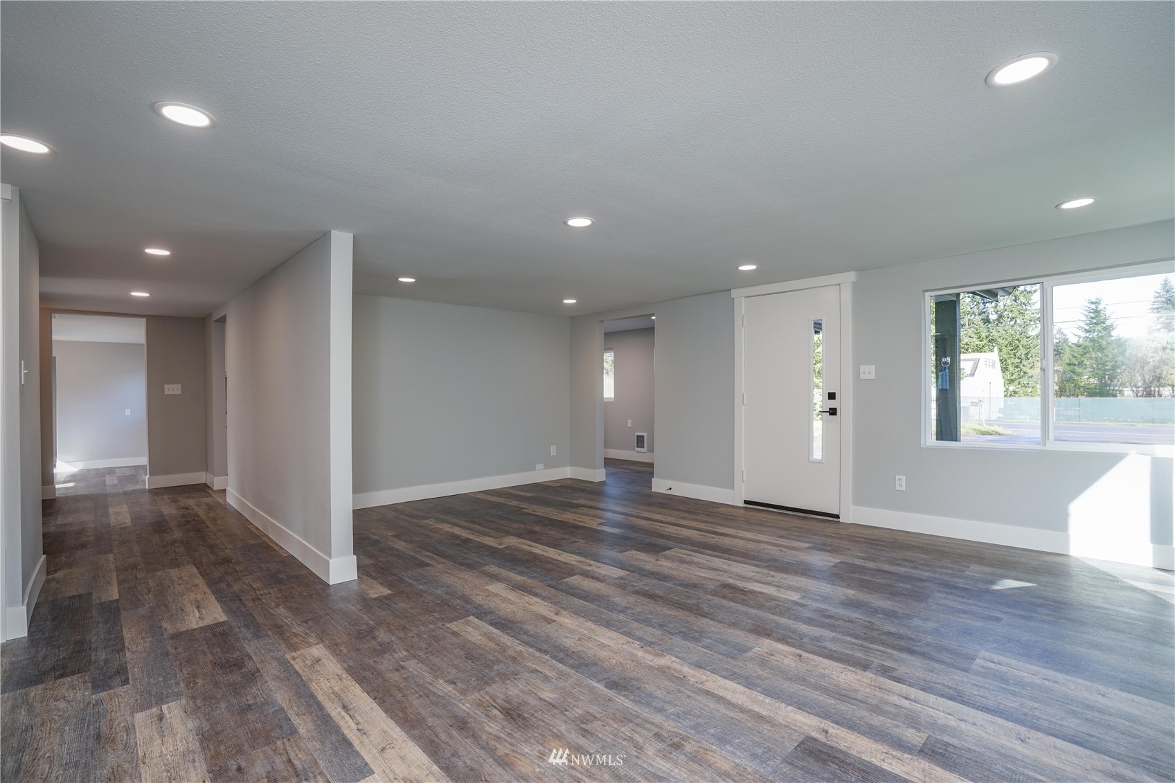 8126 Canyon Road East Puyallup, WA 98371 - Photo 14 of 37 a view of an empty room with wooden floor and a window