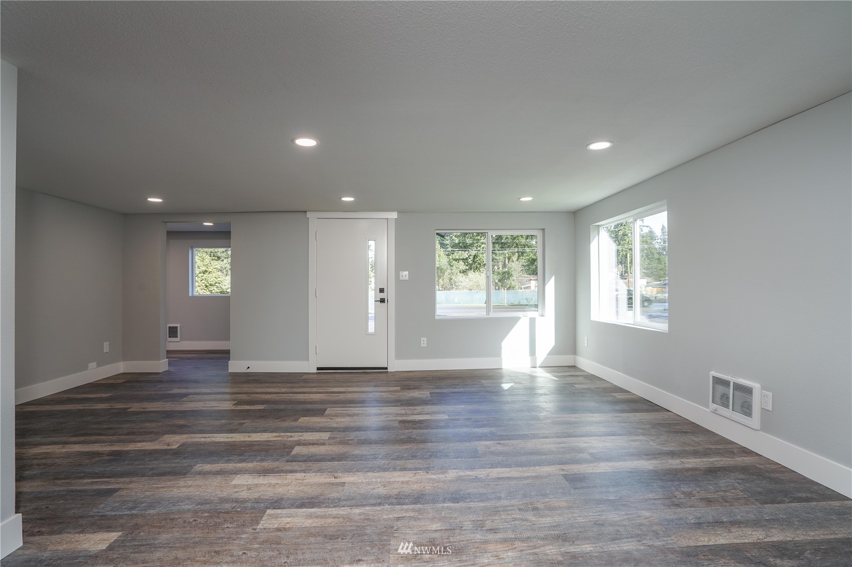 8126 Canyon Road East Puyallup, WA 98371 - Photo 15 of 37 a view of an empty room with wooden floor and a window