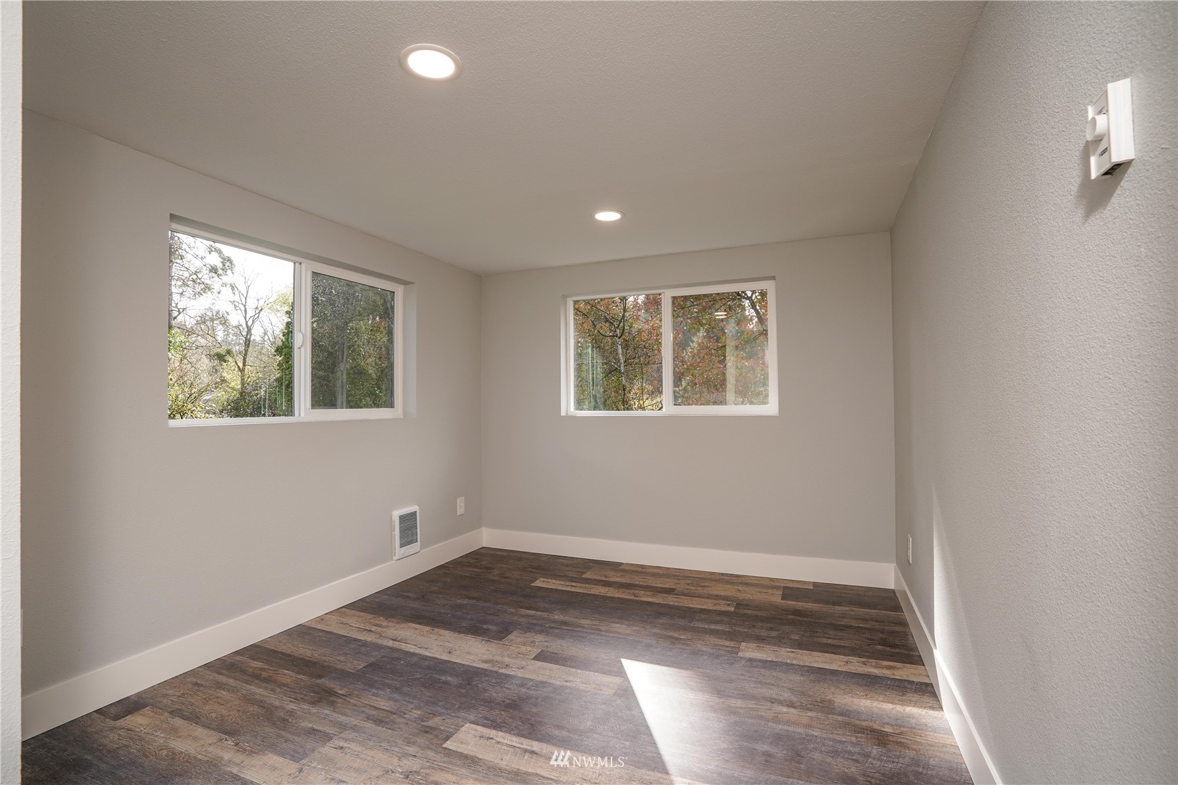 8126 Canyon Road East Puyallup, WA 98371 - Photo 16 of 37 a view of empty room with window and wooden floor