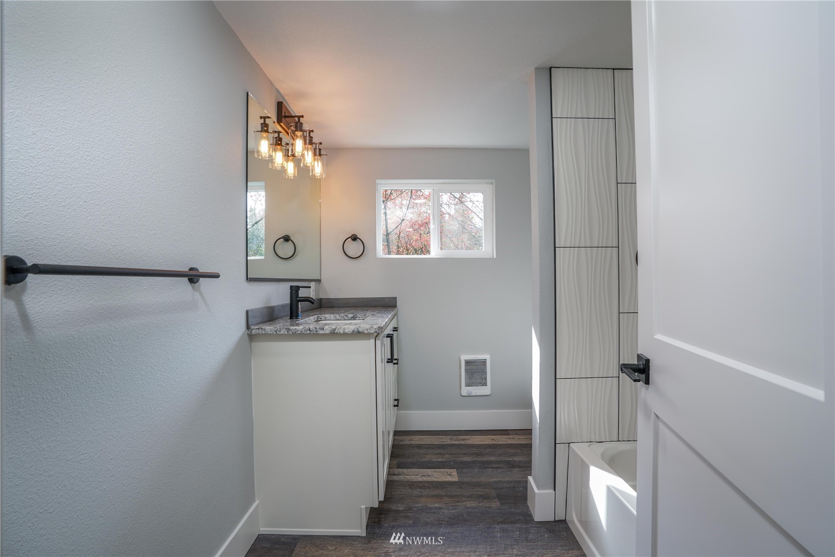 8126 Canyon Road East Puyallup, WA 98371 - Photo 17 of 37 a bathroom with a sink a toilet and shower