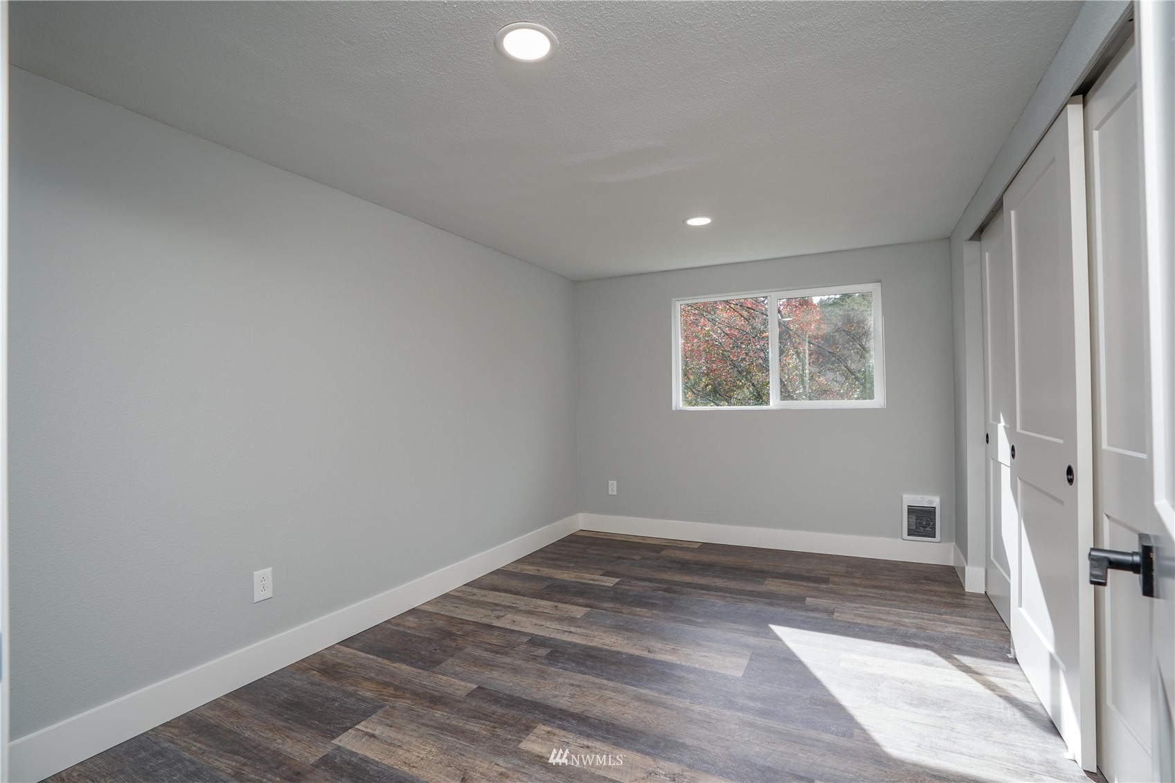 8126 Canyon Road East Puyallup, WA 98371 - Photo 18 of 37 a view of an empty room with wooden floor and a window