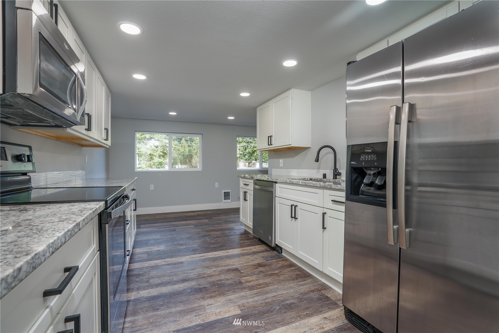 8126 Canyon Road East Puyallup, WA 98371 - Photo 20 of 37 a kitchen with a sink stove and refrigerator