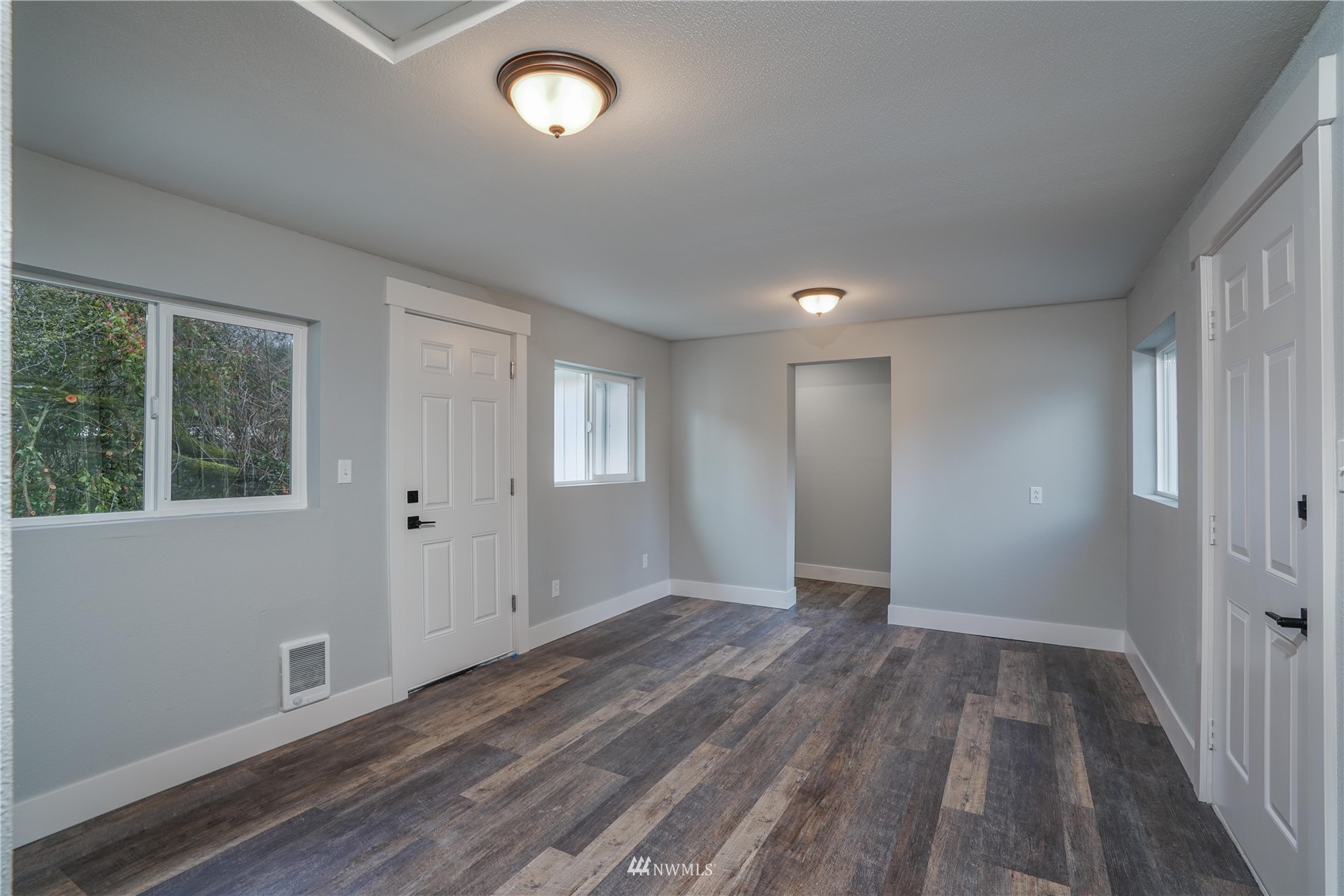 8126 Canyon Road East Puyallup, WA 98371 - Photo 26 of 37 a view of an empty room with wooden floor and a window