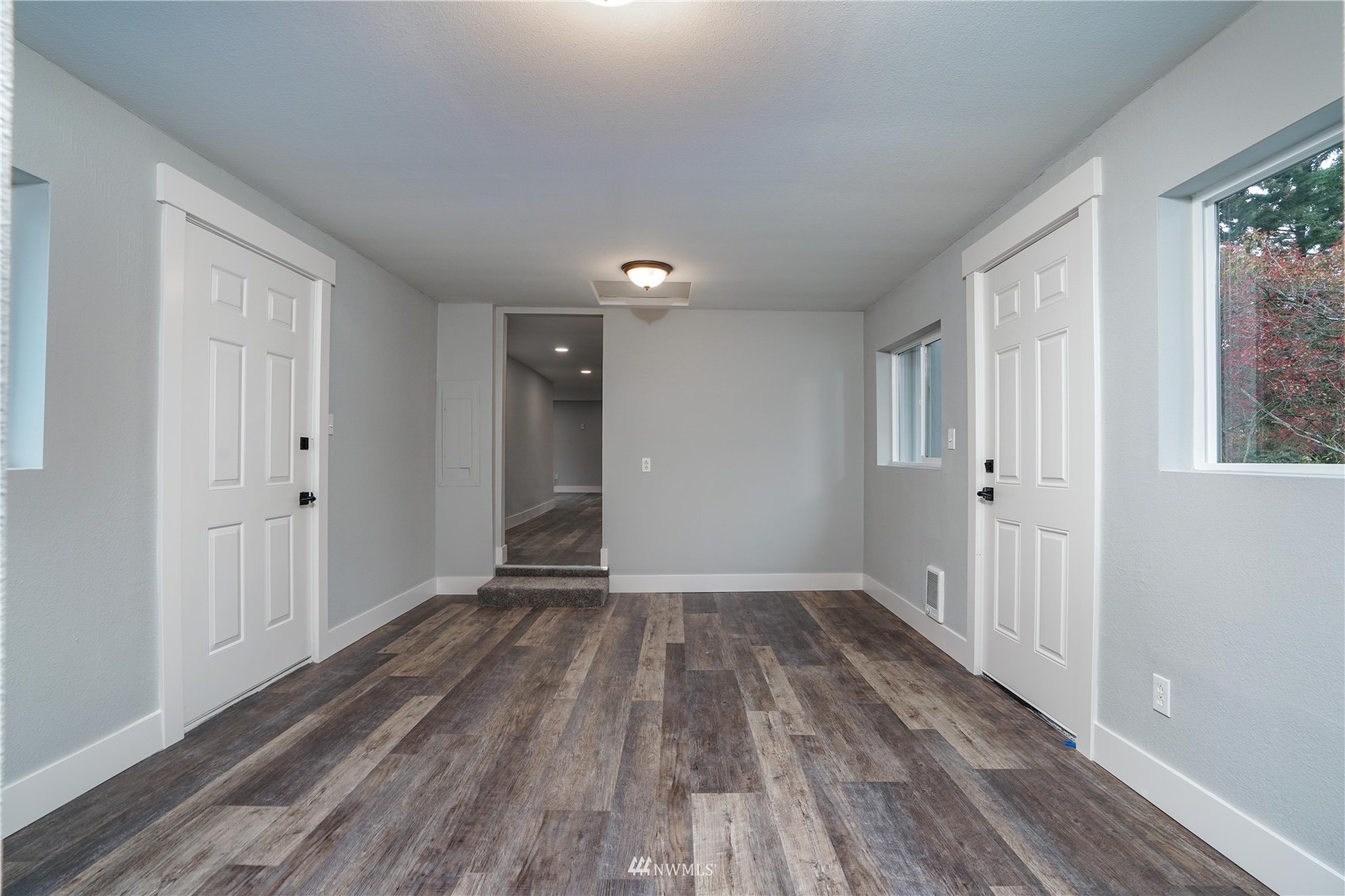8126 Canyon Road East Puyallup, WA 98371 - Photo 27 of 37 a view of an empty room with wooden floor and a window