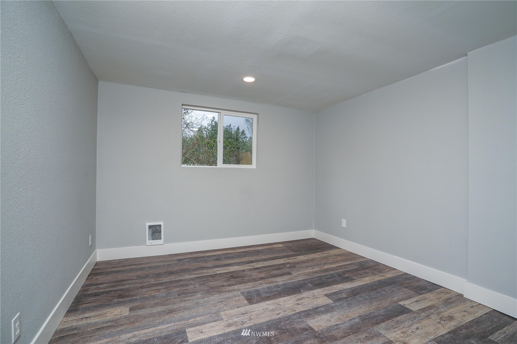8126 Canyon Road East Puyallup, WA 98371 - Photo 29 of 37 a view of empty room with wooden floor