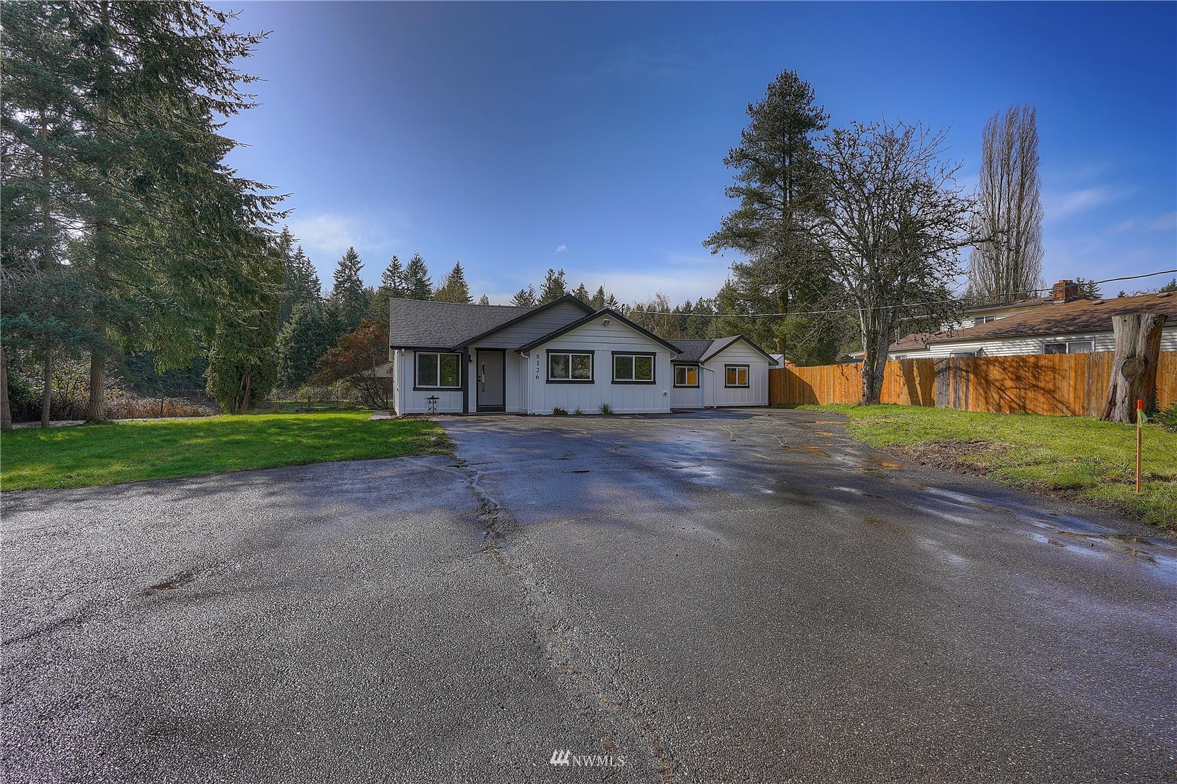 8126 Canyon Road East Puyallup, WA 98371 - Photo 3 of 37 a front view of a house with a yard and garage