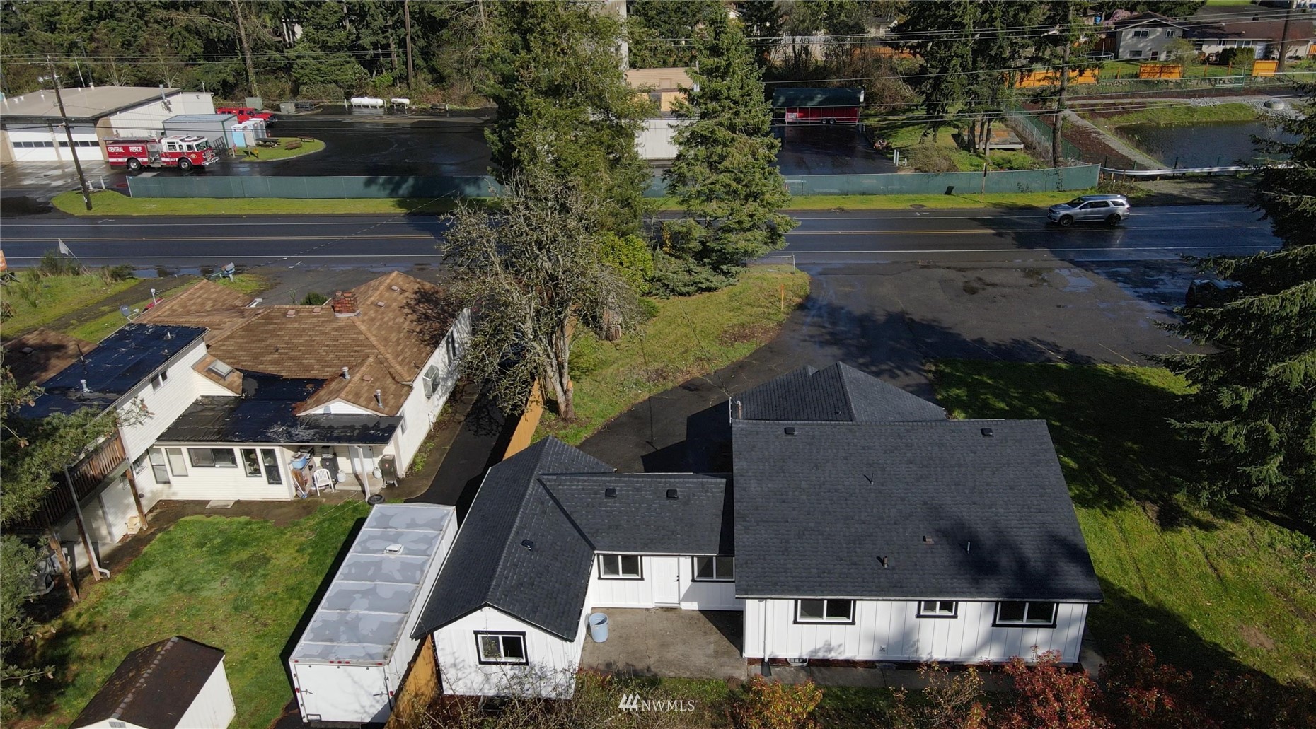 8126 Canyon Road East Puyallup, WA 98371 - Photo 36 of 37 an aerial view of a house with a lake view