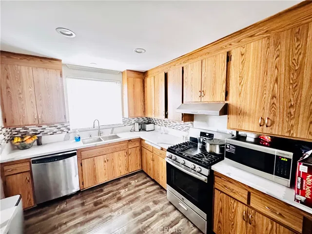 a kitchen with a sink stove and cabinets