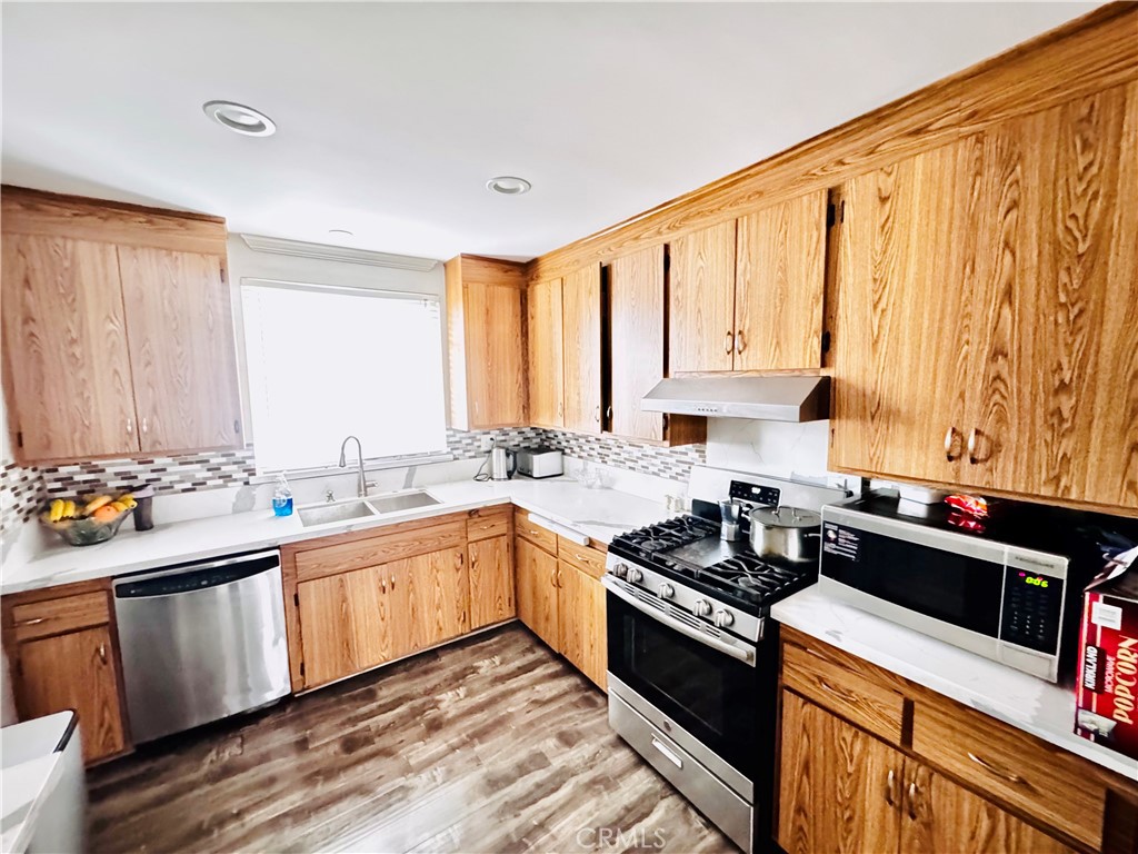 10152 Stanwin Avenue Arleta, CA 91331 - Photo 13 of 42 a kitchen with a sink stove and cabinets