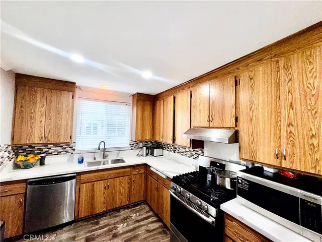 a kitchen with a sink stove top oven and cabinets