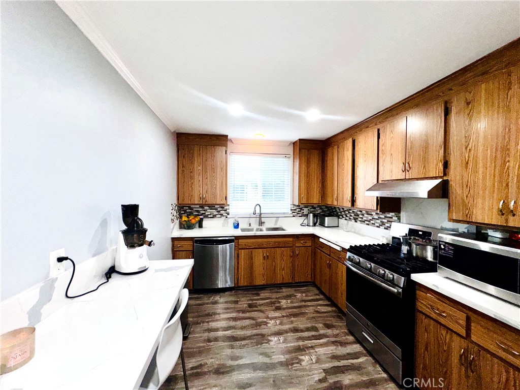 10152 Stanwin Avenue Arleta, CA 91331 - Photo 15 of 42 a kitchen with lots of counter top space and sink