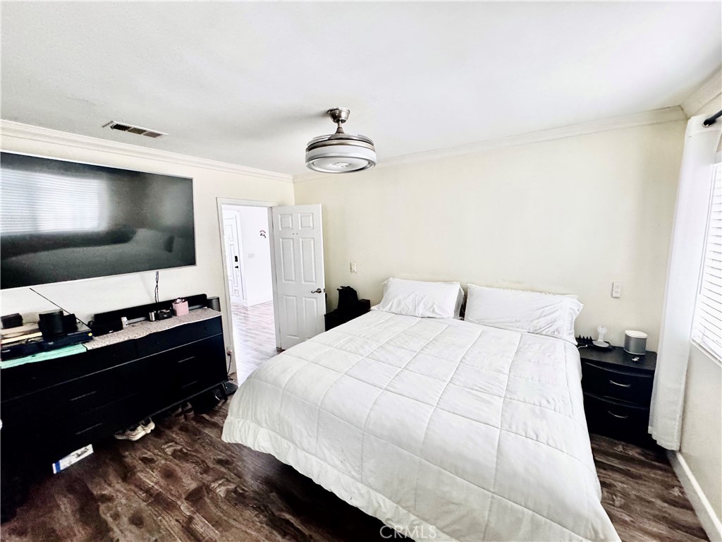 10152 Stanwin Avenue Arleta, CA 91331 - Photo 17 of 42 a bedroom with a bed and a flat screen tv