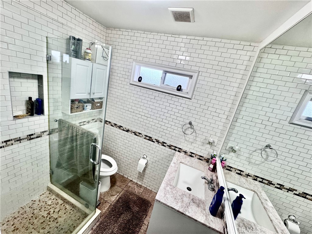 10152 Stanwin Avenue Arleta, CA 91331 - Photo 18 of 42 a bathroom with a sink and toilet