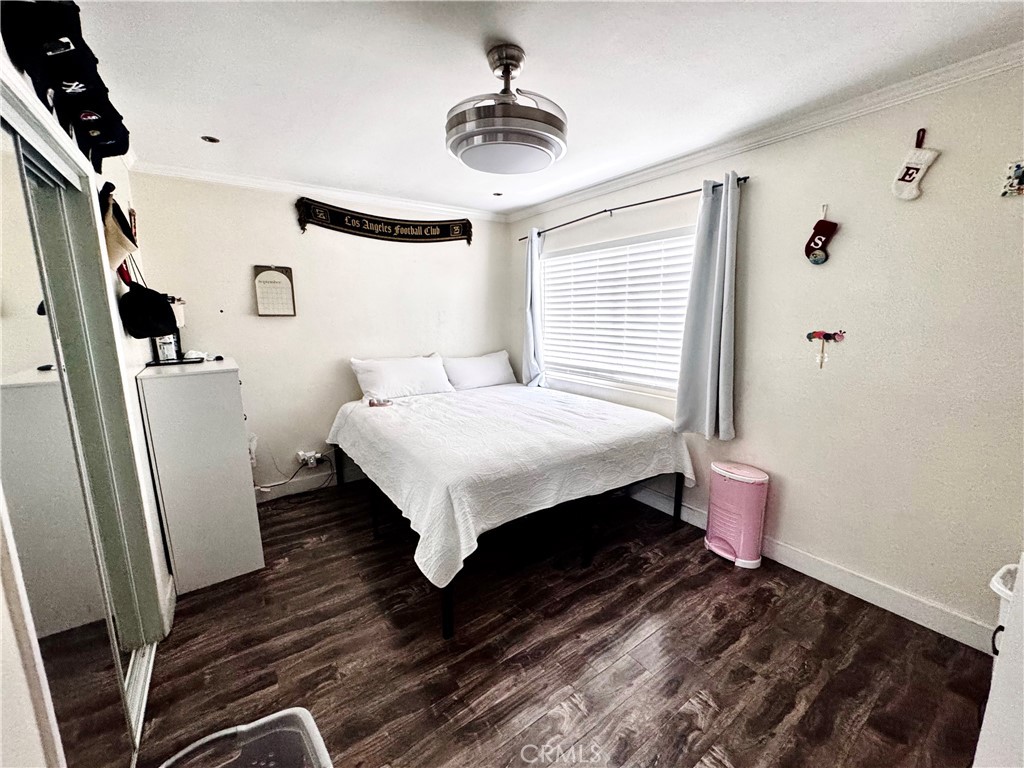 10152 Stanwin Avenue Arleta, CA 91331 - Photo 21 of 42 a bedroom with a bed and a chandelier