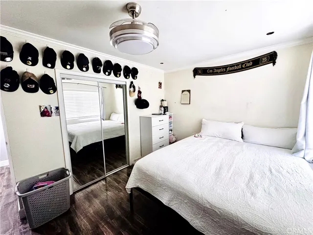 a bedroom with a bed and a mirror