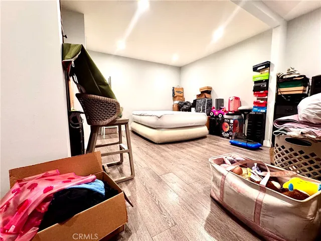 a bedroom with furniture and a wooden floor