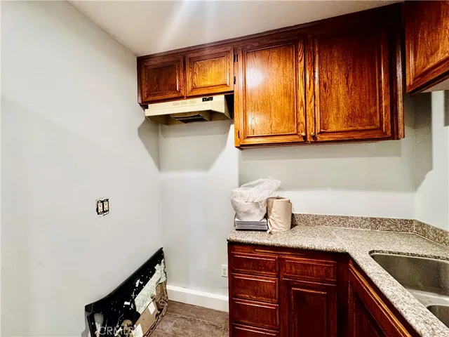 a kitchen with a sink cabinets and a window