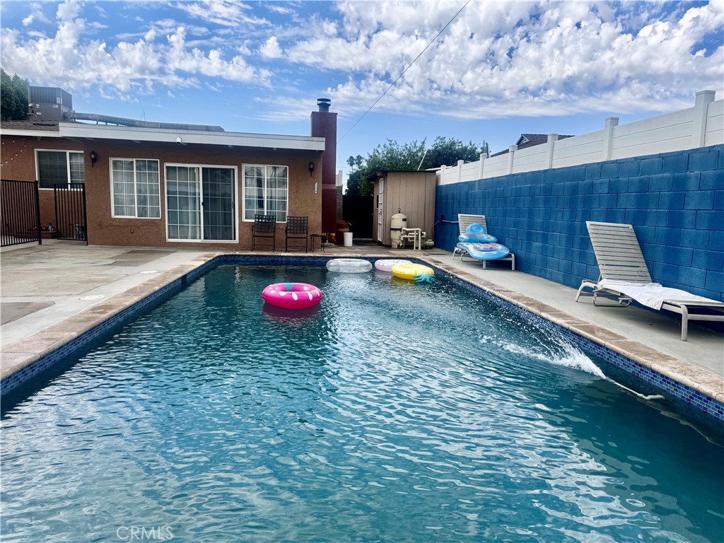 10152 Stanwin Avenue Arleta, CA 91331 - Photo 36 of 42 a view of a backyard with furniture and a fire pit