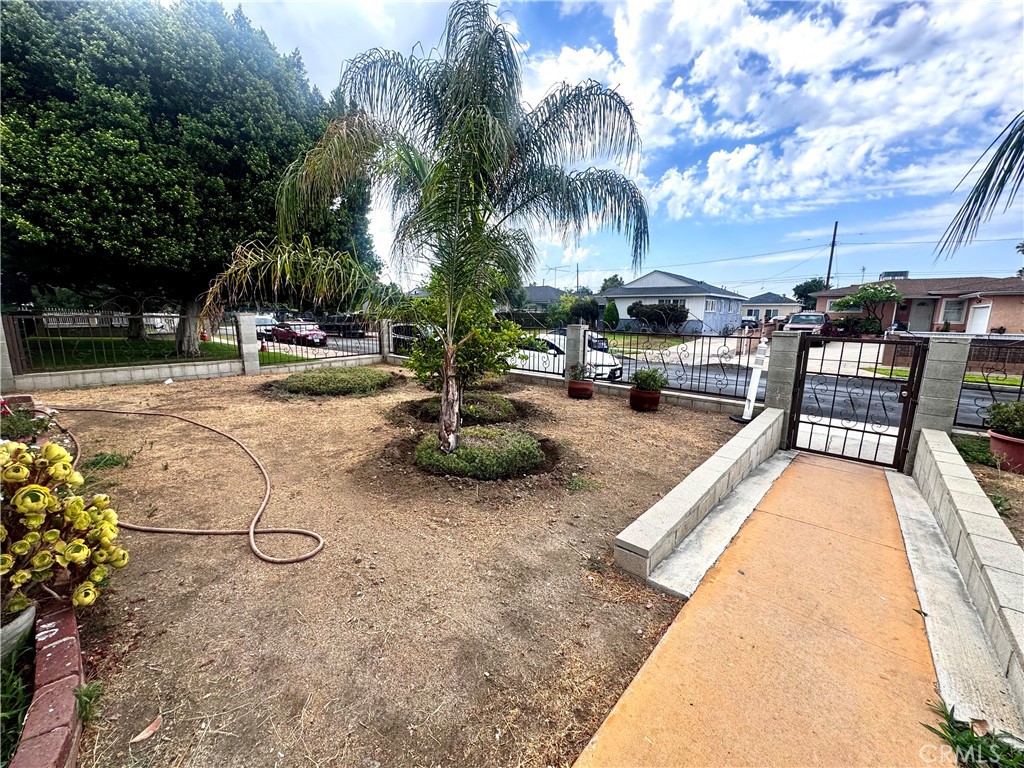 10152 Stanwin Avenue Arleta, CA 91331 - Photo 42 of 42 a row of palm trees and swimming pool in the backyard of a house