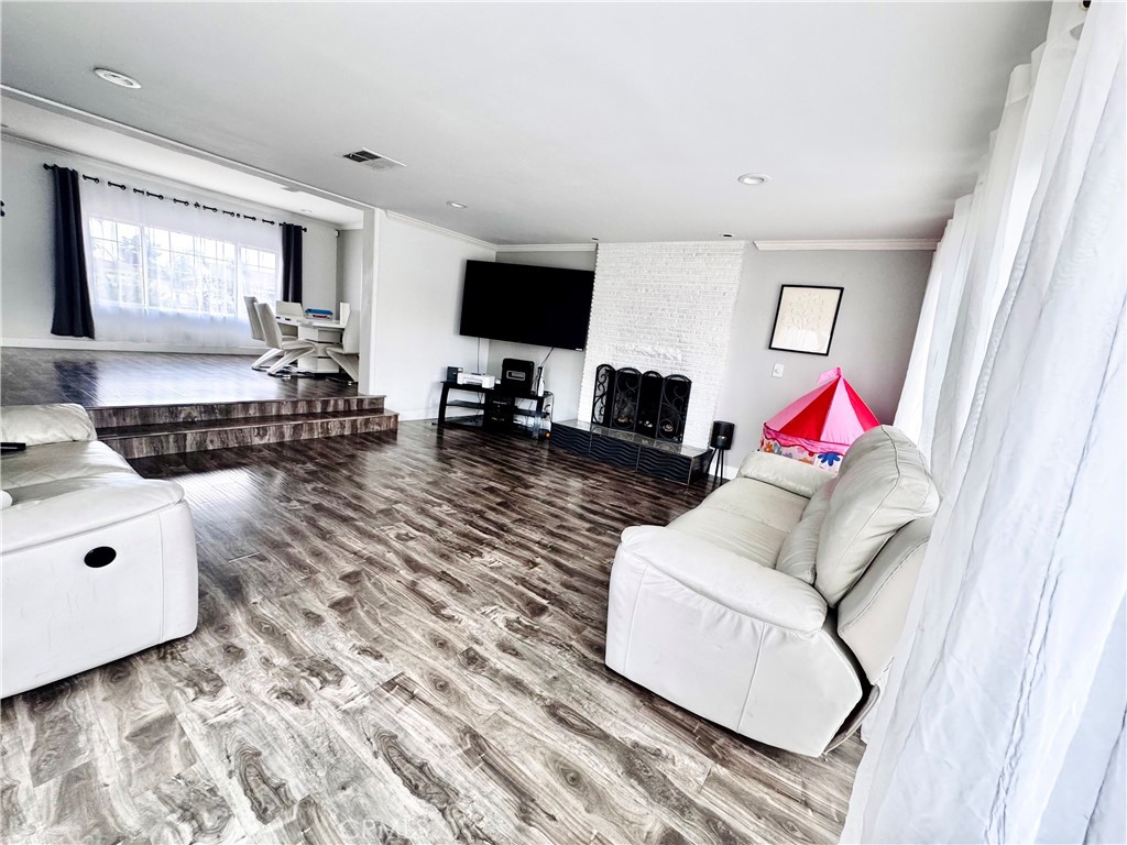 10152 Stanwin Avenue Arleta, CA 91331 - Photo 8 of 42 a living room with furniture and a flat screen tv