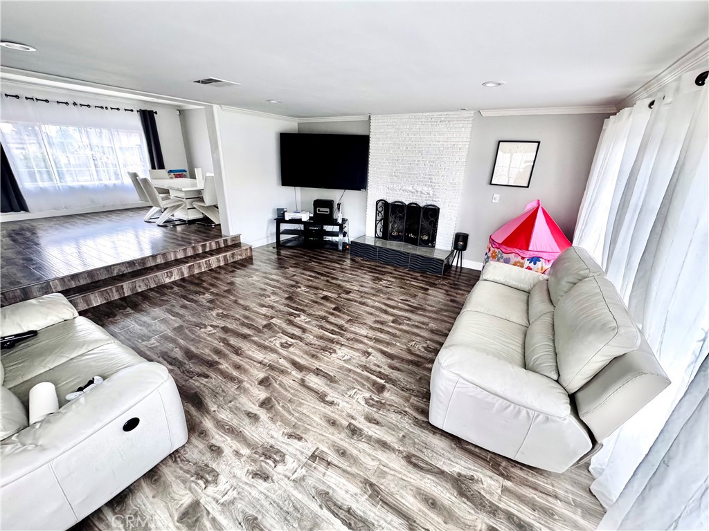 10152 Stanwin Avenue Arleta, CA 91331 - Photo 10 of 42 a living room with furniture and a flat screen tv