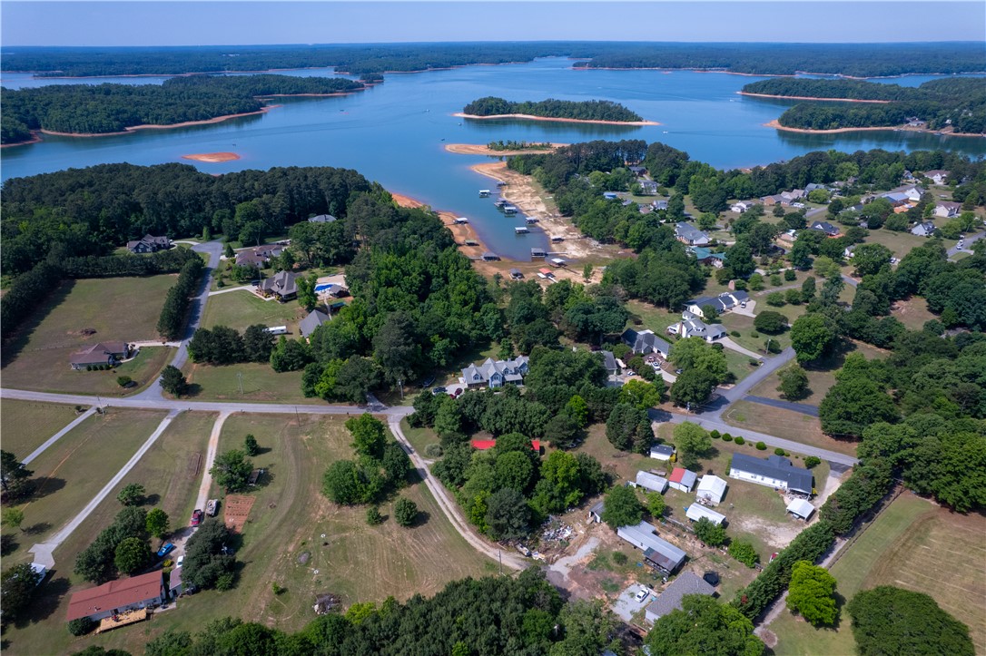 1504 Double Springs Road Townville, SC 29689 - Photo 36 of 41 This captivating aerial view showcases a vibrant community nestled by the water's edge, surrounded by lush trees.