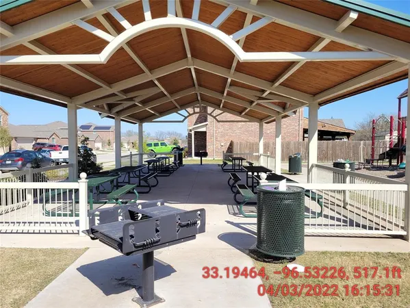 a roof deck with table and chairs