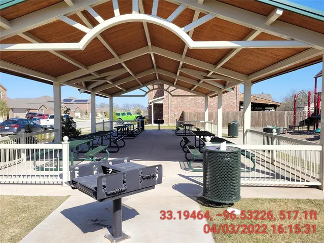 a roof deck with table and chairs