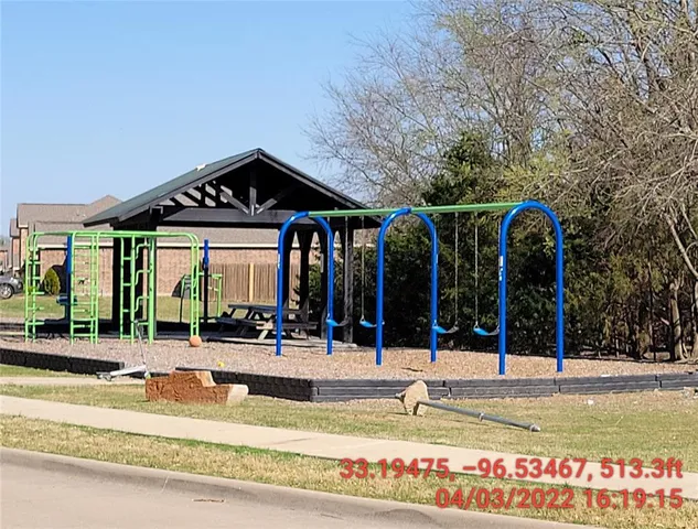 a view of a building with large trees and plants