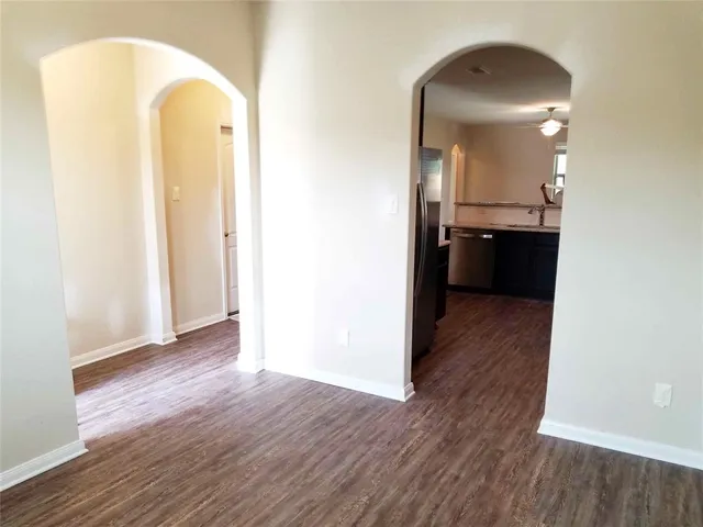 a view of a room with wooden floor and a bathroom
