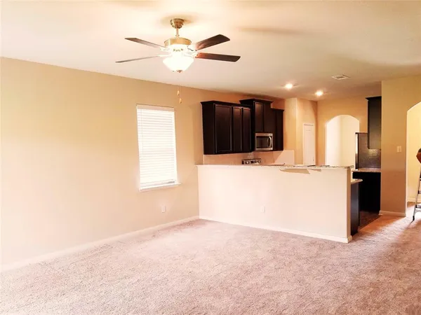 a view of a kitchen with a sink and a microwave