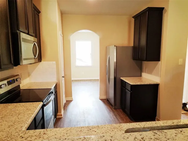 a kitchen with a wooden floor and a sink