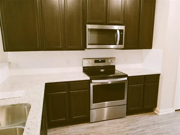 a kitchen with a sink and a microwave