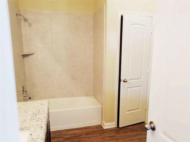 a bathroom with a bathtub and shower