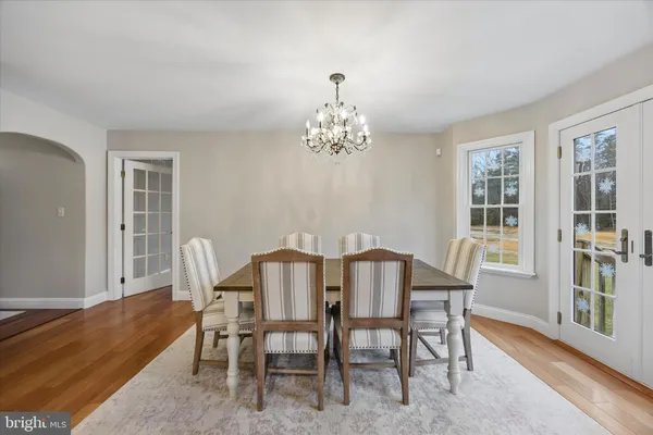 a view of a dining room with furniture and chandelier