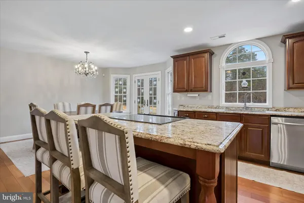 a dining table with chairs and kitchen view