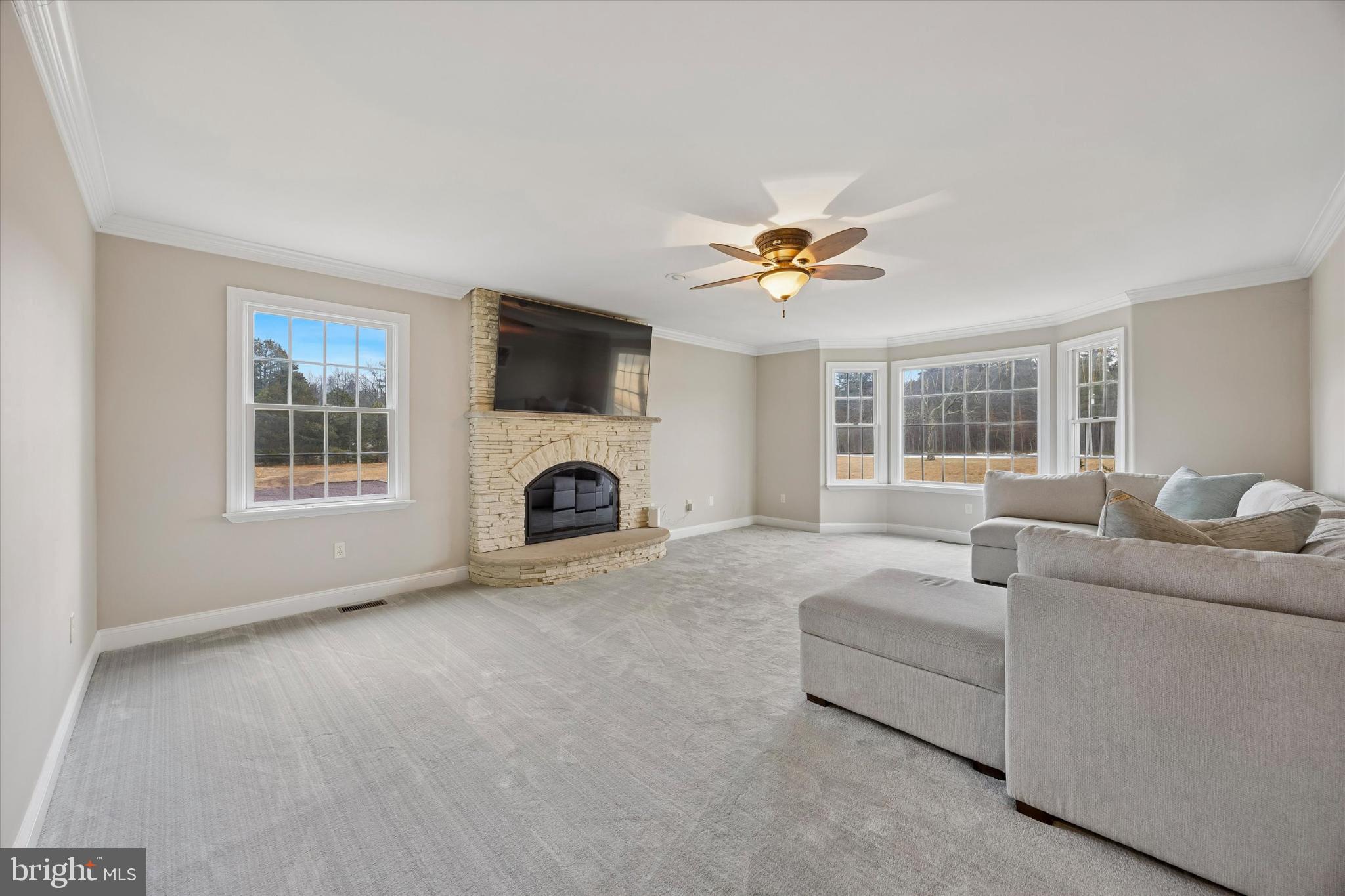 883 Atsion Road Shamong, NJ 08088 - Photo 19 of 42 a living room with furniture a fireplace and a flat screen tv