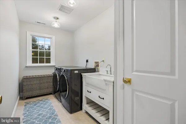 a utility room with cabinets washer and dryer