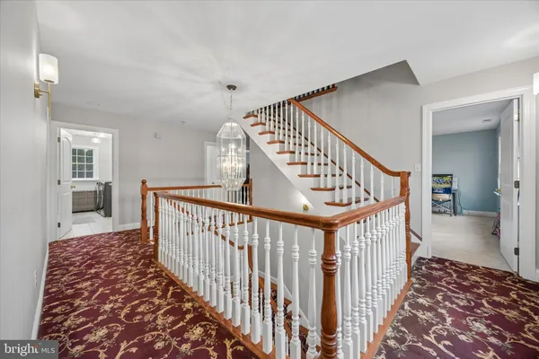 a view of a hallway with wooden floor and stairs