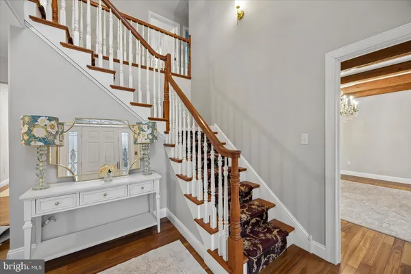 a view of entryway and hall with wooden floor