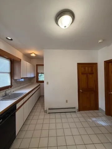 a large kitchen with a stove and a refrigerator