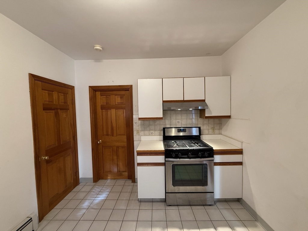 55-57 Evans Street Medford, MA 02155 - Photo 14 of 40 a kitchen with a stove and a refrigerator
