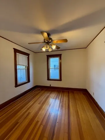 a view of an empty room and wooden floor