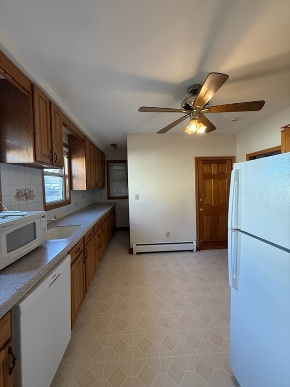55-57 Evans Street Medford, MA 02155 - Photo 18 of 40 a view of a kitchen with a sink and a refrigerator