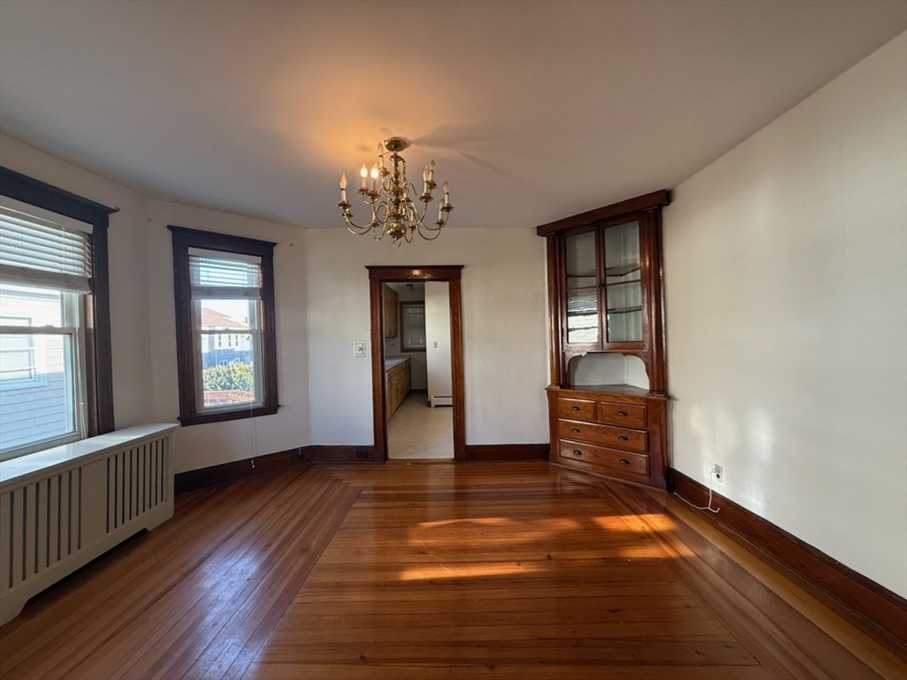 55-57 Evans Street Medford, MA 02155 - Photo 19 of 40 wooden floor in an empty room with a window