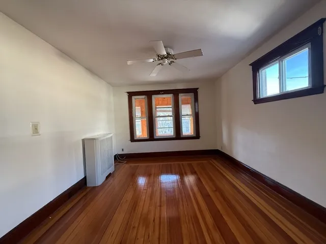 wooden floor in an empty room with a window