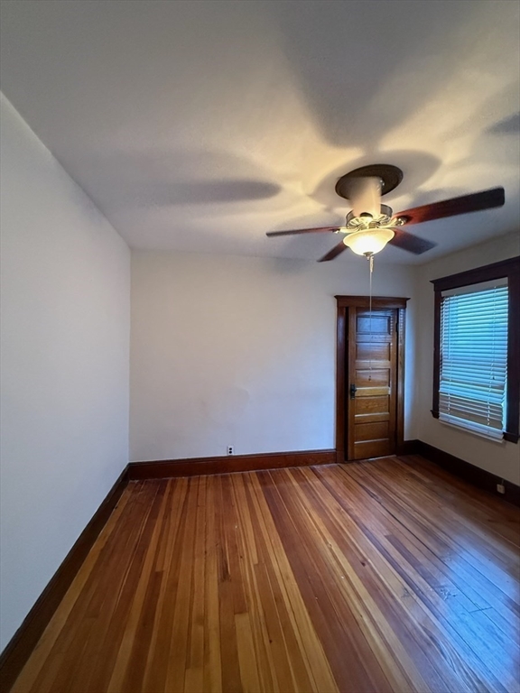 55-57 Evans Street Medford, MA 02155 - Photo 23 of 40 a view of an empty room with wooden floor and window