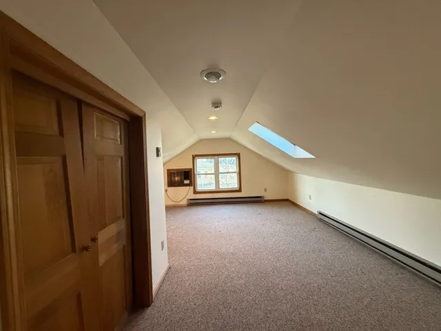 a view of a livingroom with an empty space and a fireplace
