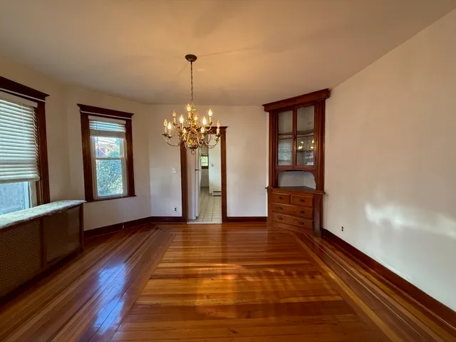 a view of a room with wooden floor staircase and a kitchen