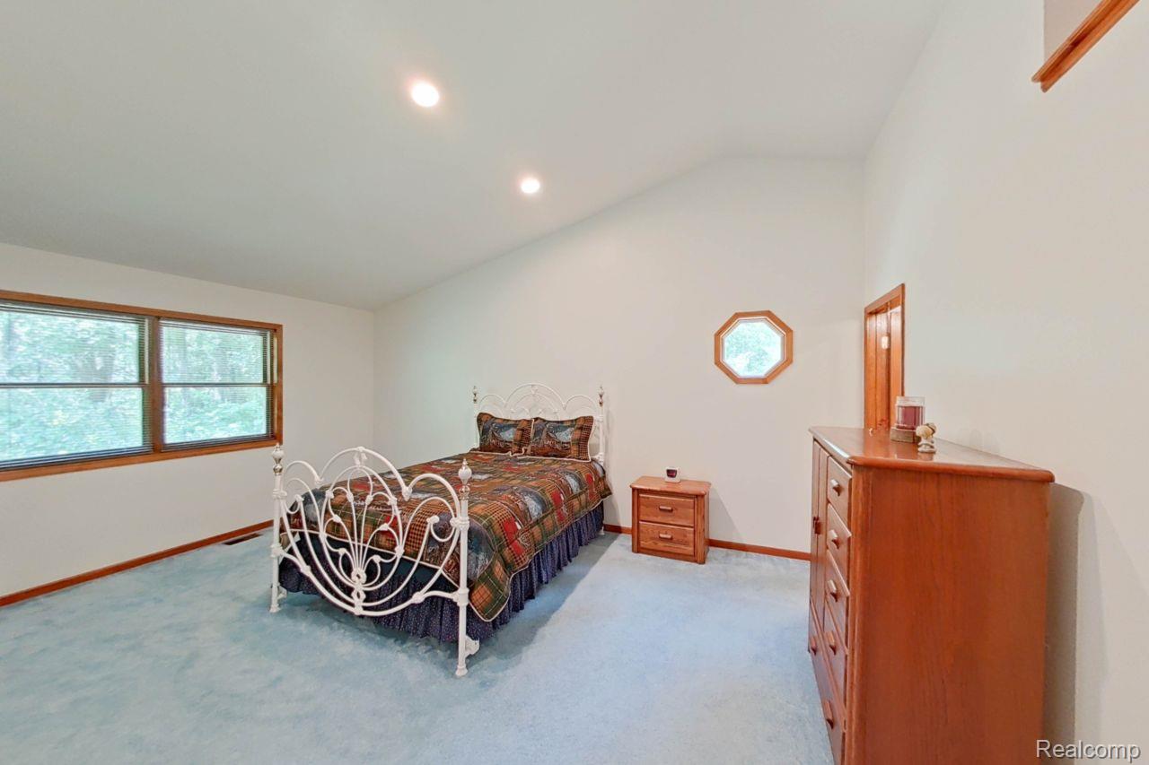 10201 Washburn Road Goodrich, MI 48438 - Photo 42 of 85 Spacious room featuring a vaulted ceiling with recessed lighting, light blue carpeting, and white walls